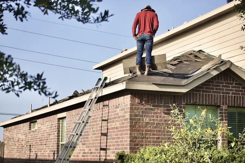 Professional roofer working on a residential roof in Woodview Park